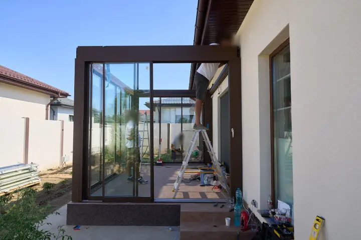 Fitting the sliding glass panels on the terrace
