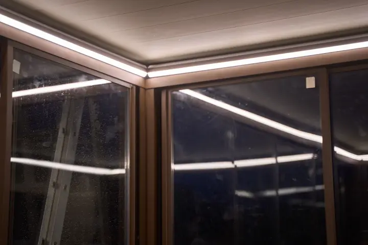Warm LED light reflected by the louvred ceiling