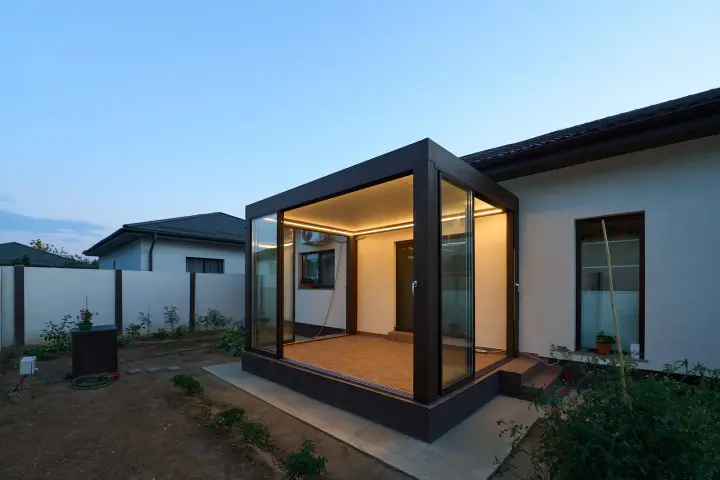 Corner of the bioclimatic pergola with LED lighting at dusk
