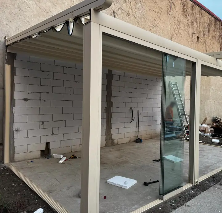 Frameless glass panels stacked at the end of the opening