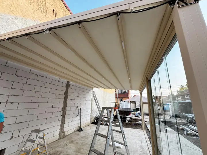 Glass enclosure under the extended pergola membrane