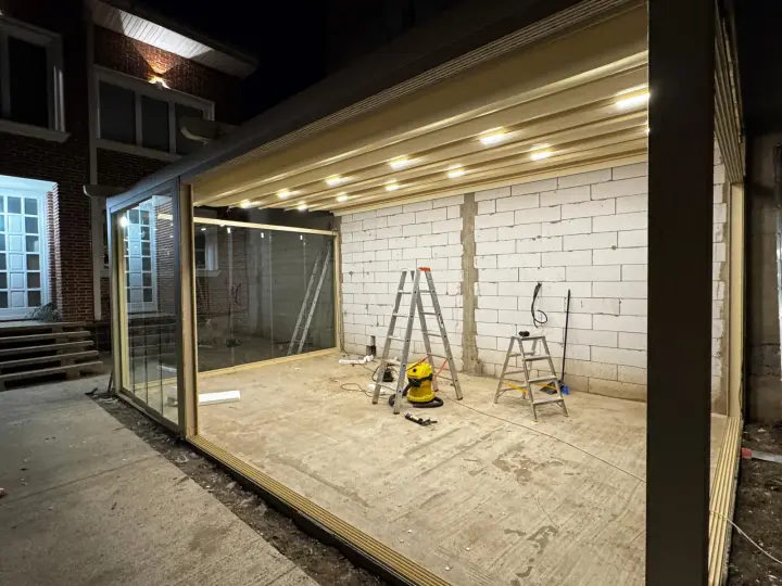 Overall view of the glass-enclosed Wave pergola at night
