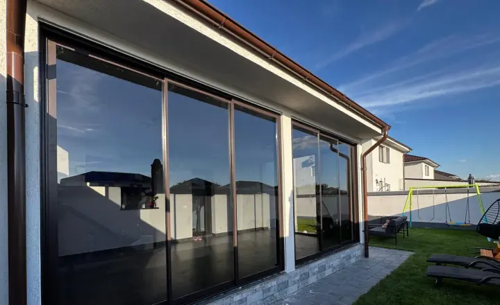 Sliding glass with brown frames on the covered terrace