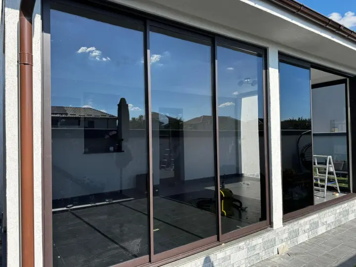 Sliding glass panels along the long side of the terrace