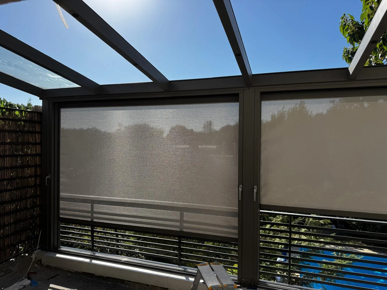 Upper-floor terrace with a glass roof and two zip screens lowered
