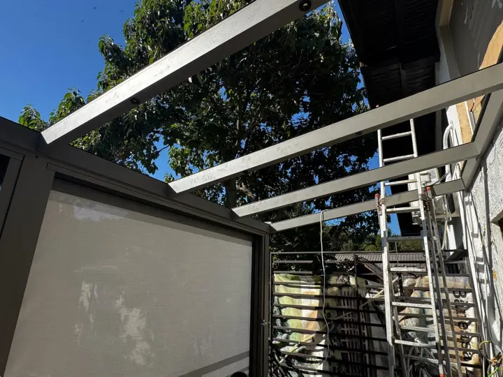 Side zip screen seen from below, under the roof rafters