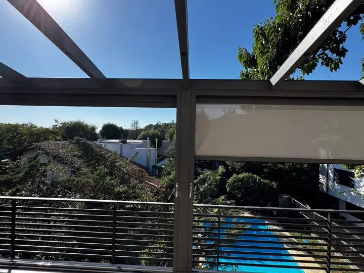 Open bay onto the garden, with the neighbouring zip screen raised halfway