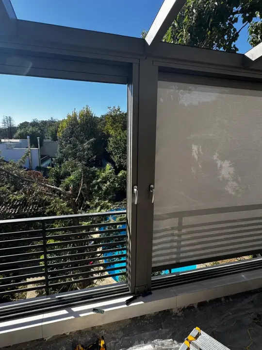Side of the terrace with the zip screen lowered and the next bay open